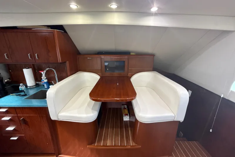 Slide: The Image of Luxurious 1992 Ocean Yachts 48 Super Sport interior with elegant dining area and wooden cabinetry. - 13