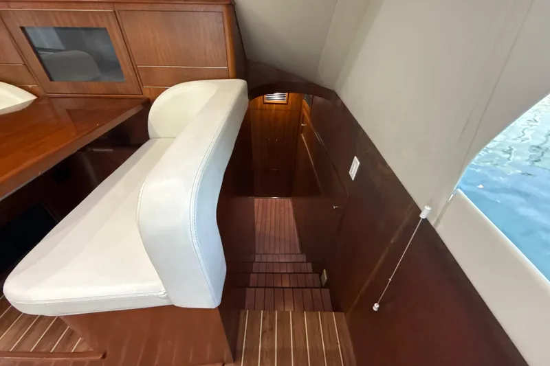 Slide: The Image of Interior of 1992 Ocean Yachts 48 Super Sport, featuring wooden stairs and seating. - 17
