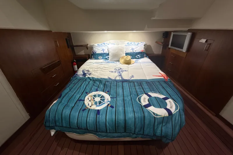 Slide: The Image of Cozy bedroom in 1992 Ocean Yachts 48 Super Sport with nautical-themed bedding. - 18