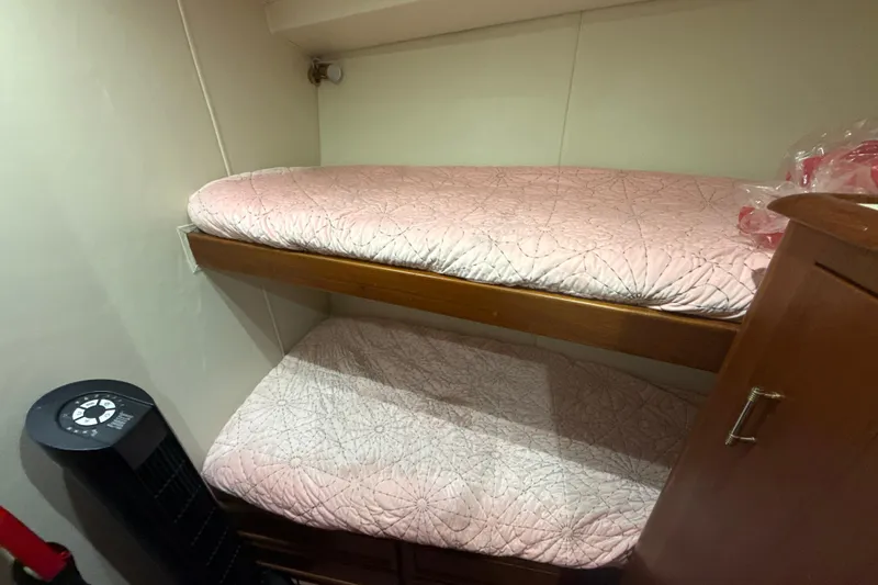 Slide: The Image of Bunk beds in 1992 Ocean Yachts 48 Super Sport cabin with pink bedding. - 19