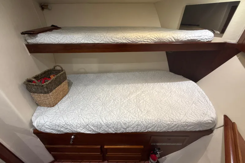 Slide: The Image of Bunk beds in 1992 Ocean Yachts 48 Super Sport cabin with storage basket and fire extinguisher. - 21