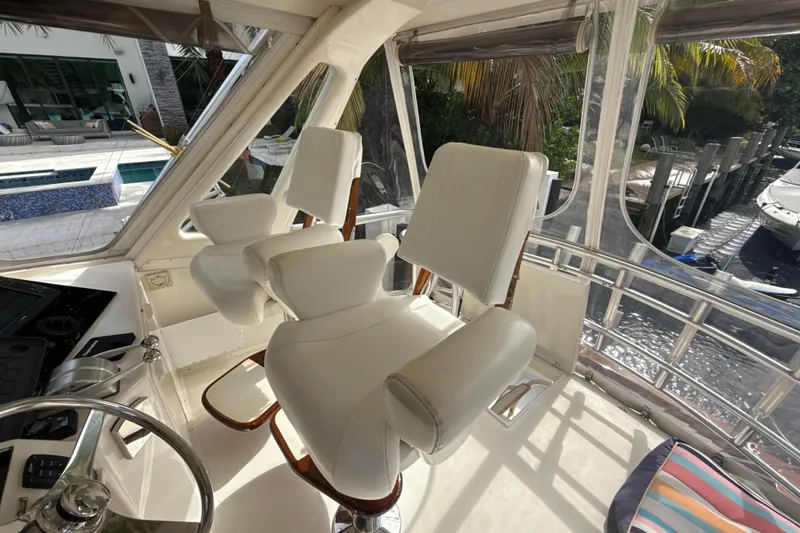 Slide: The Image of Interior of 1992 Ocean Yachts 48 Super Sport with white captain's chairs and helm. - 24