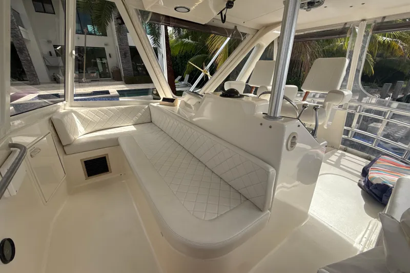 Slide: The Image of Interior of 1992 Ocean Yachts 48 Super Sport with white seating and helm area. - 26