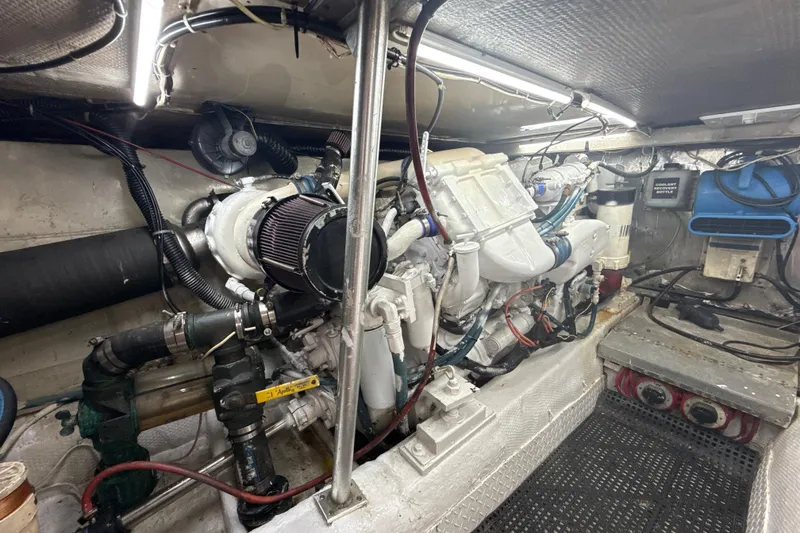 Slide: The Image of Engine room of 1992 Ocean Yachts 48 Super Sport, showcasing mechanical components and wiring. - 28