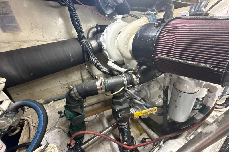 Slide: The Image of Engine room of a 1992 Ocean Yachts 48 Super Sport, showcasing mechanical components. - 31