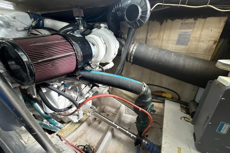 Slide: The Image of Engine room of 1992 Ocean Yachts 48 Super Sport with visible air filter and hoses. - 32