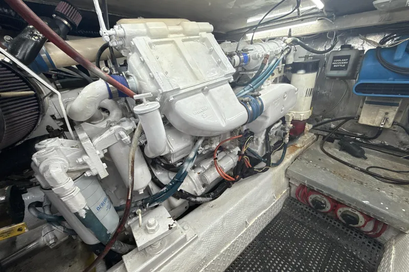Slide: The Image of Engine room of a 1992 Ocean Yachts 48 Super Sport, showcasing detailed machinery and components. - 33