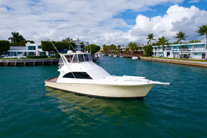 Slide: The Image of 1992 Ocean Yachts 48 Super Sport cruising in a scenic waterfront setting. - 4