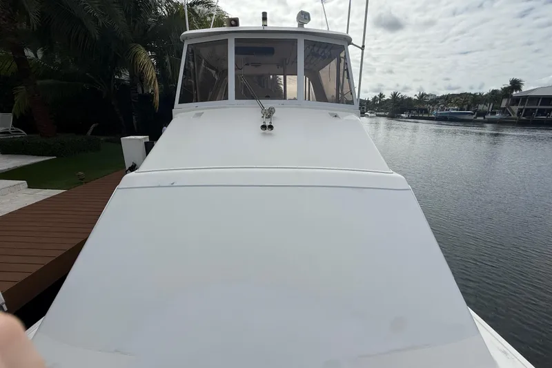 Slide: The Image of 1992 Ocean Yachts 48 Super Sport on calm water, dockside view. - 42