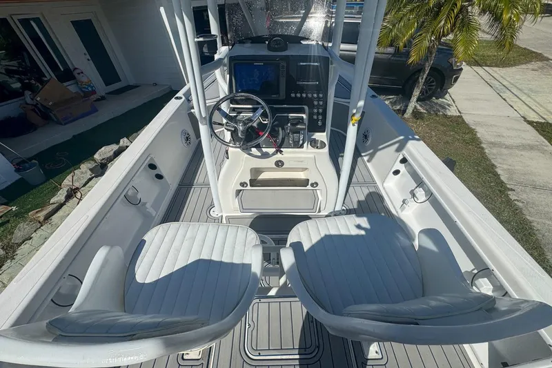 Slide: The Image of 2018 Blue Wave 2400 PureBay boat interior with steering console and seating. - 18