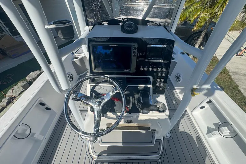 Slide: The Image of 2018 Blue Wave 2400 PureBay boat console with steering wheel and navigation equipment. - 20