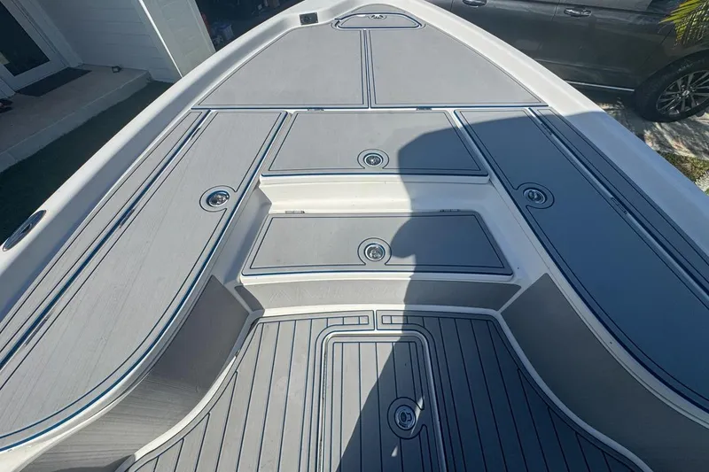 Slide: The Image of 2018 Blue Wave 2400 PureBay boat deck with storage compartments and sleek design. - 24