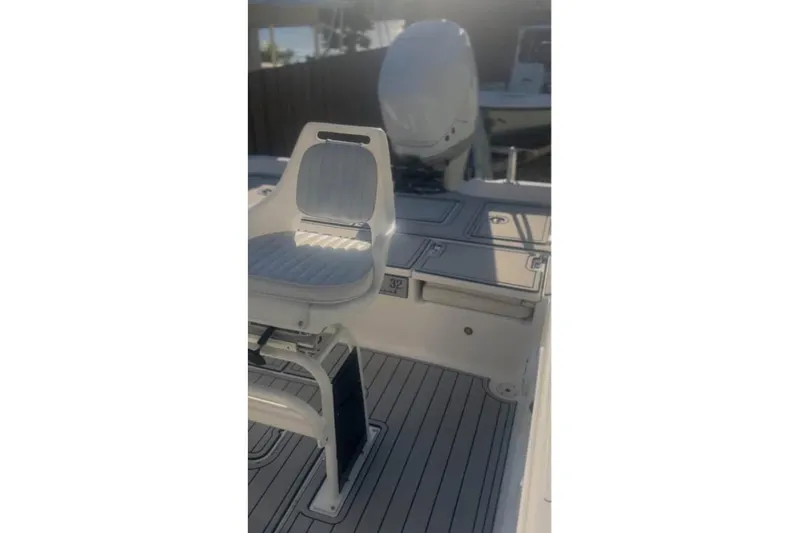 Slide: The Image of 2018 Blue Wave 2400 PureBay boat on driveway, surrounded by palm trees and suburban homes. - 3