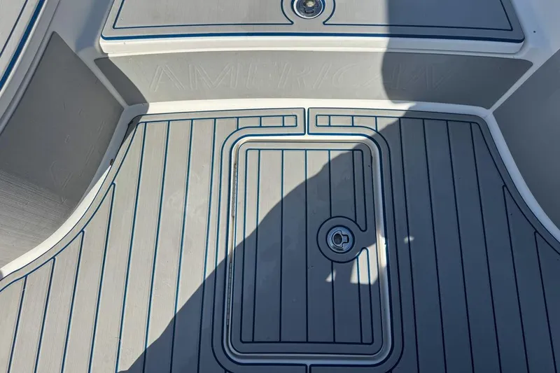 Slide: The Image of 2018 Blue Wave 2400 PureBay boat deck with sleek gray and blue design. - 38
