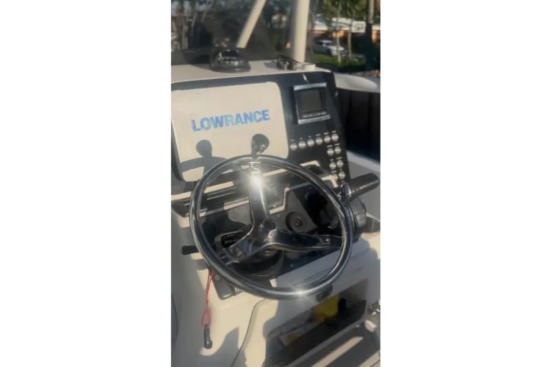 Slide: The Image of 2018 Blue Wave 2400 PureBay boat on trailer, parked in driveway under cloudy sky. - 4