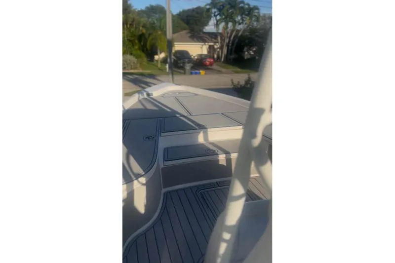 Slide: The Image of 2018 Blue Wave 2400 PureBay boat on trailer, parked in front of a house. - 5