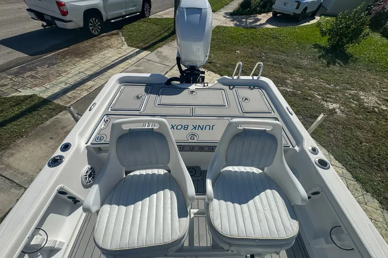 Slide: The Image of 2018 Blue Wave 2400 PureBay boat interior with two white seats and storage compartments. - 51