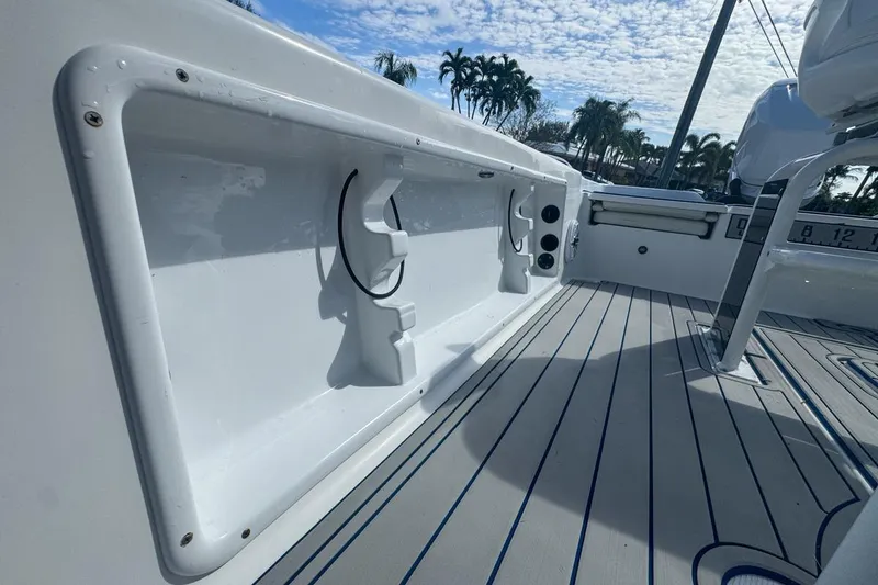Slide: The Image of 2018 Blue Wave 2400 PureBay boat deck with rod holders and sleek design. - 58