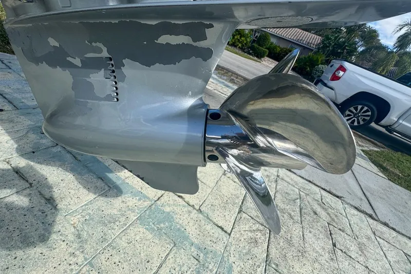 Slide: The Image of Close-up of a 2018 Blue Wave 2400 PureBay boat propeller on a paved surface. - 72