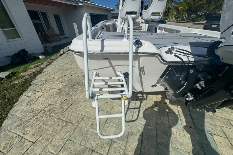 Slide: The Image of 2018 Blue Wave 2400 PureBay boat with ladder on paved driveway. - 8