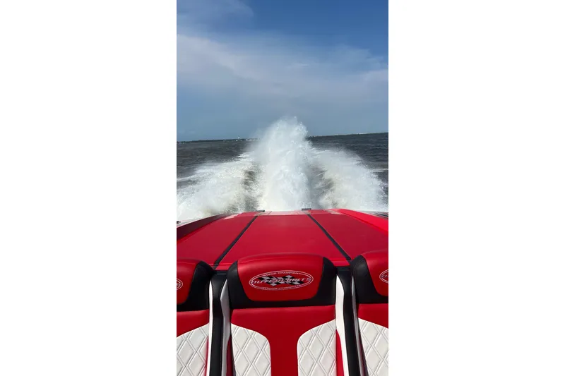 Slide: The Image of Red 2022 Outerlimits SL41 speedboat creating a wake on open water. - 10