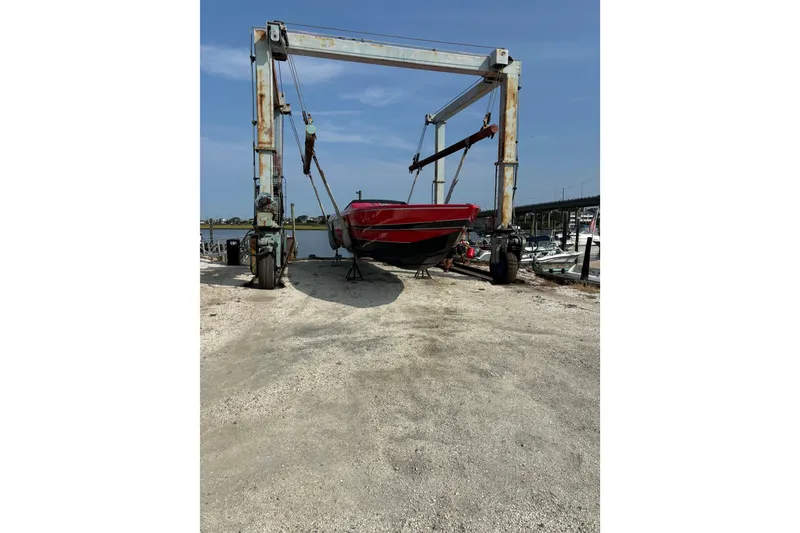 Slide: The Image of 2022 Outerlimits SL41 boat on a lift at a marina. - 11