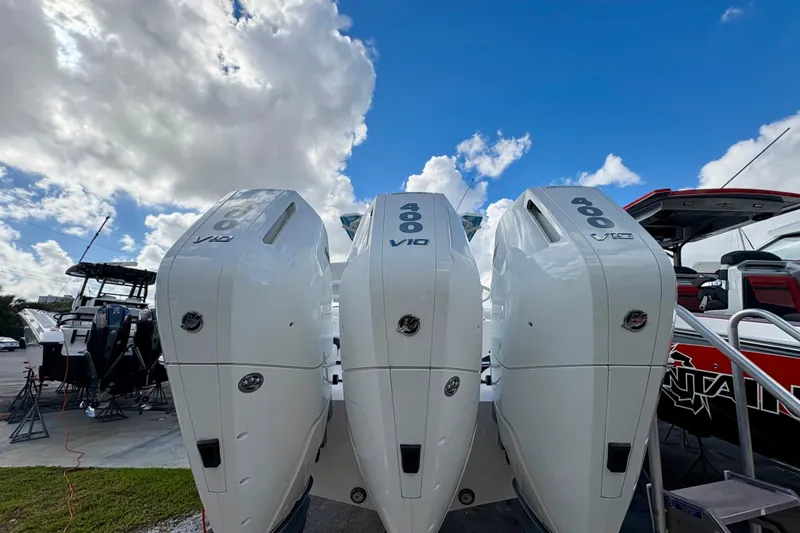 Slide: The Image of 2025 Fountain 38 Center Console with triple 400 V10 engines under a blue sky. - 2