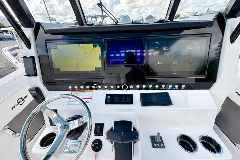 Slide: The Image of 2025 Fountain 38 Center Console dashboard with navigation and control screens. - 6