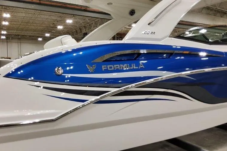 Slide: The Image of 2025 Formula 310 Bowrider I/O boat in a showroom. - 37