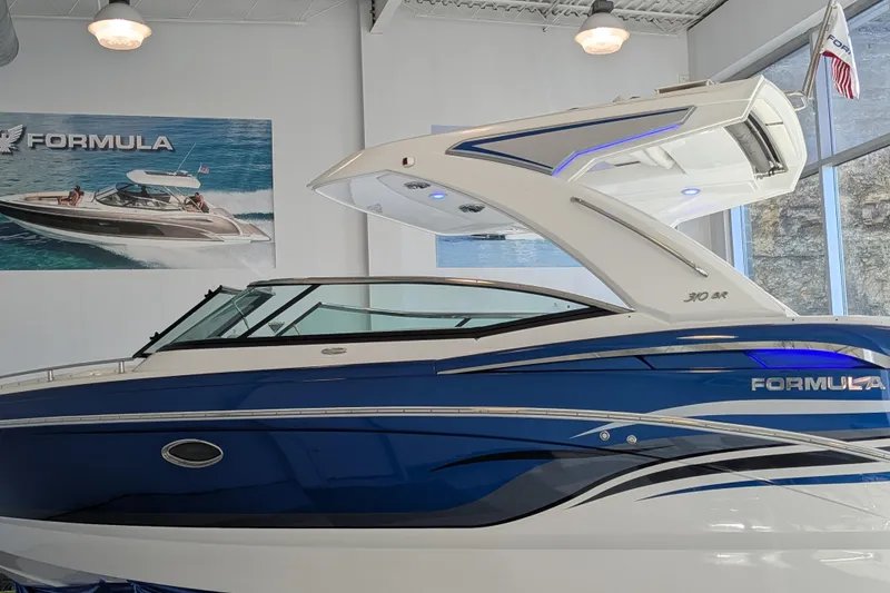 Slide: The Image of 2025 Formula 310 Bowrider I/O boat in showroom. - 5