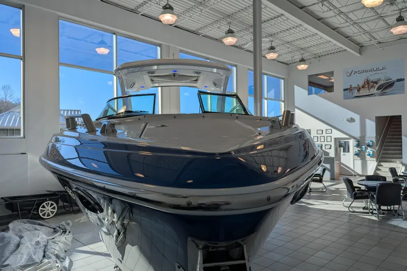 Slide: The Image of 2025 Formula 310 Bowrider I/O in showroom, modern interior view. - 7