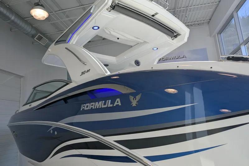 Slide: The Image of 2025 Formula 310 Bowrider I/O boat in showroom. - 8