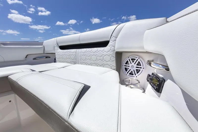 Slide: The Image of Manufacturer Provided Image: 2025 Tiara Yachts 34 LS interior with white seating and speaker, under a clear blue sky. - 10