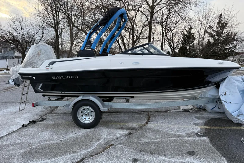 The Image of 2026 Bayliner VR4 Bowrider OB on trailer, parked outdoors in winter setting. - 0