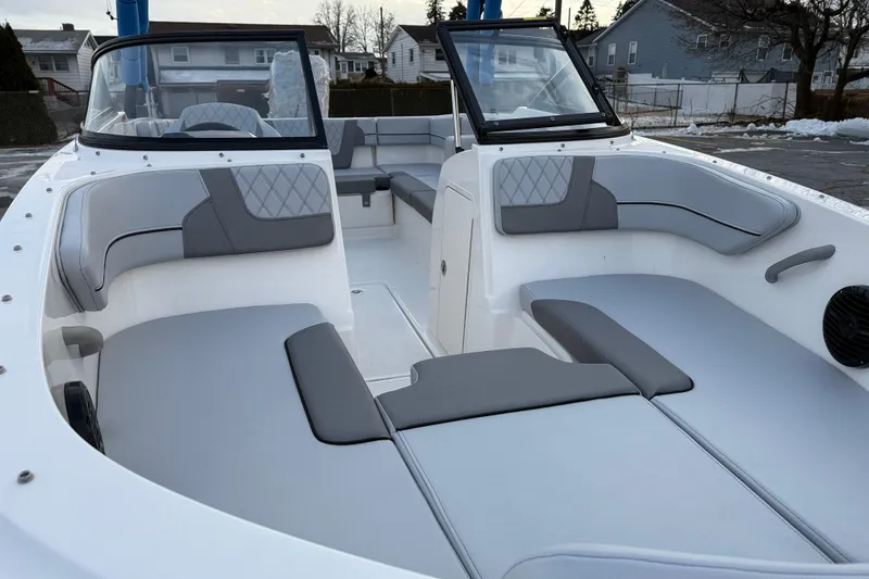 Slide: The Image of 2026 Bayliner VR4 Bowrider OB interior with gray seating and open deck layout. - 11