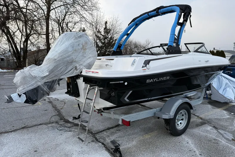 Slide: The Image of 2026 Bayliner VR4 Bowrider OB on trailer, wrapped for protection, in parking lot. - 3