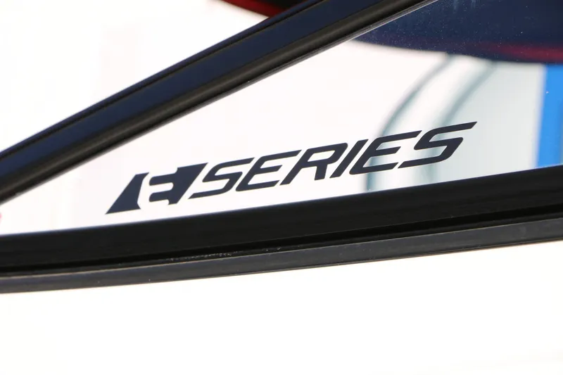Slide: The Image of Close-up of 2018 Yamaha Boats 242X E-Series logo on boat window. - 12