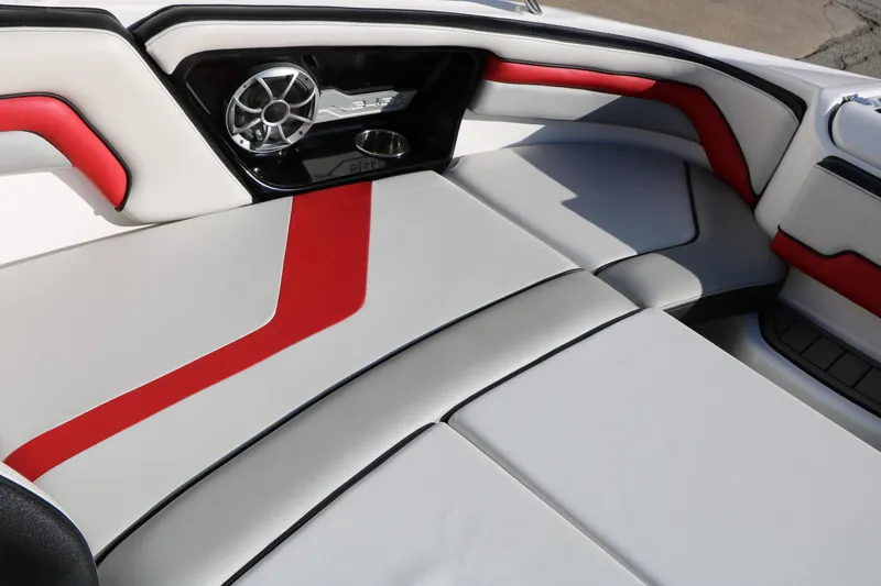 Slide: The Image of 2018 Yamaha Boats 242X E-Series interior with red and gray seating and speaker system. - 22