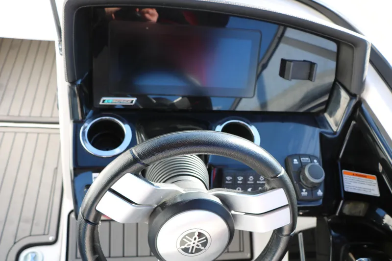 Slide: The Image of 2018 Yamaha Boats 242X E-Series dashboard with steering wheel and touchscreen display. - 28