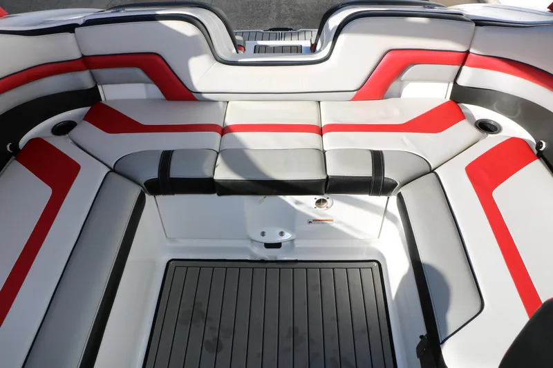 Slide: The Image of 2018 Yamaha Boats 242X E-Series interior with red and gray seating. - 37
