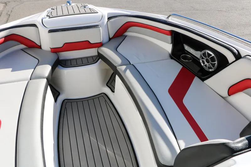 Slide: The Image of 2018 Yamaha Boats 242X E-Series interior with red and white seating, speaker, and cup holder. - 40