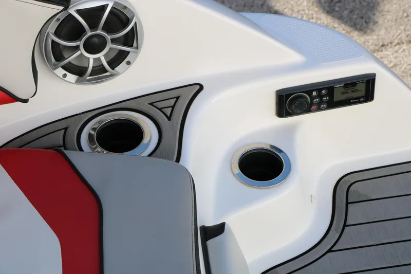 Slide: The Image of 2018 Yamaha Boats 242X E-Series interior with speaker, control panel, and cup holders. - 48