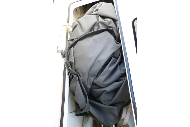 Slide: The Image of Storage compartment in 2018 Yamaha Boats 242X E-Series, containing a folded black cover. - 54