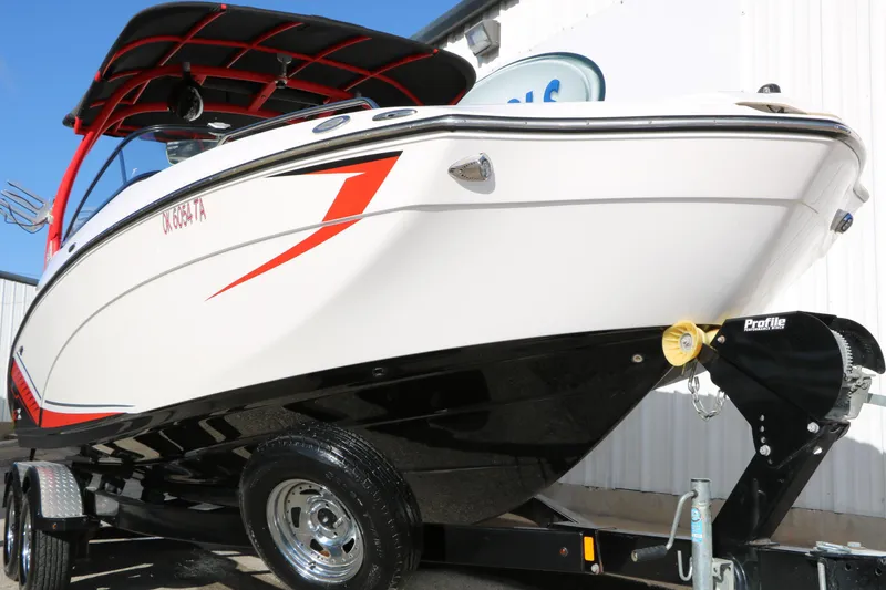 Slide: The Image of 2018 Yamaha Boats 242X E-Series on trailer, featuring sleek design and vibrant red accents. - 6