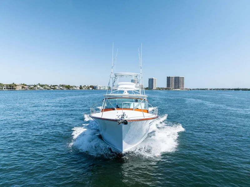 Slide: The Image of 2000 Rybovich Sportfish yacht cruising on open water, clear blue sky. - 1