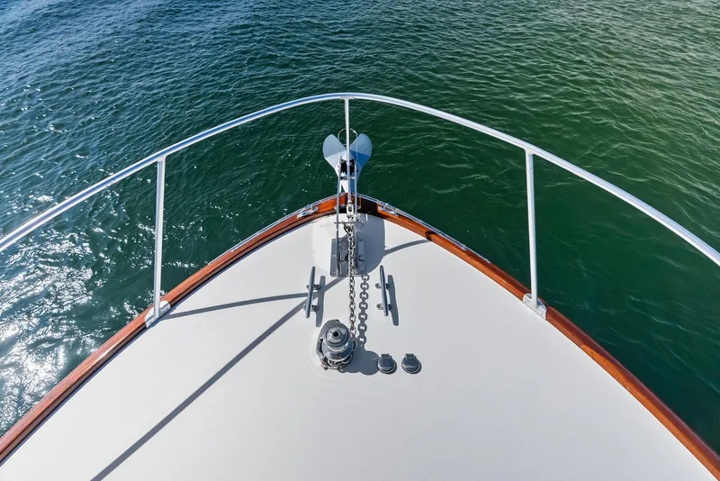 Slide: The Image of Bow of 2000 Rybovich Sportfish boat with anchor over clear water. - 13