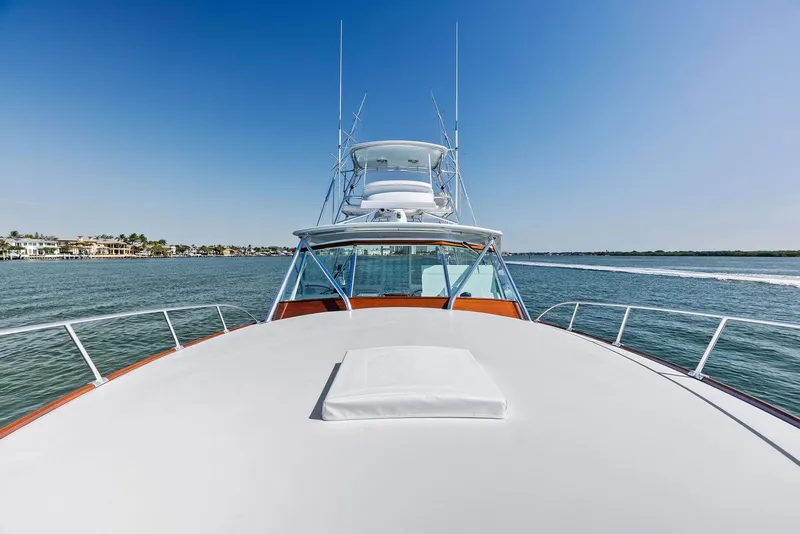 Slide: The Image of 2000 Rybovich Sportfish yacht cruising on open water under clear blue sky. - 14