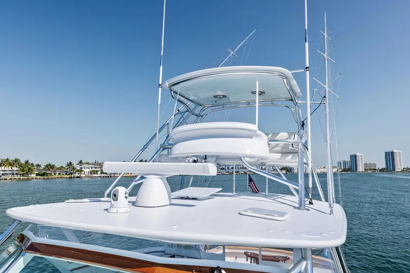 Slide: The Image of 2000 Rybovich Sportfish yacht with tower, cruising on calm waters under clear blue skies. - 15