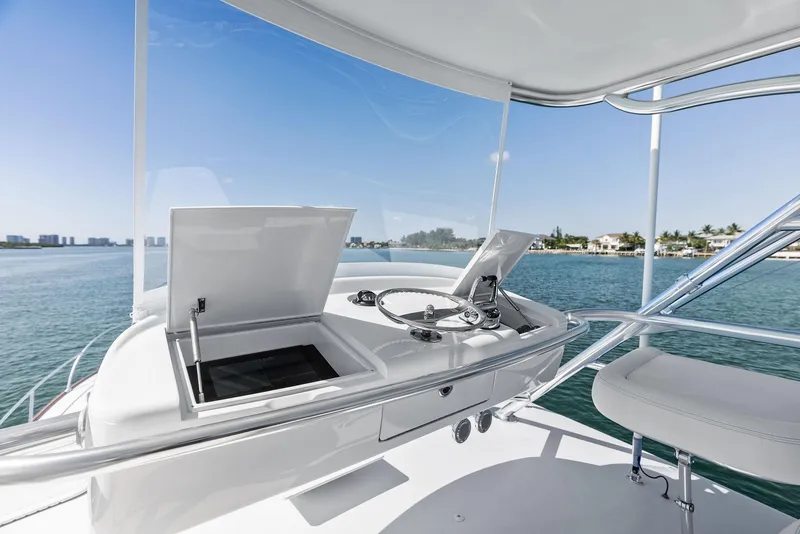 Slide: The Image of Rybovich Sportfish 2000 yacht helm with ocean view, featuring sleek design and modern controls. - 16