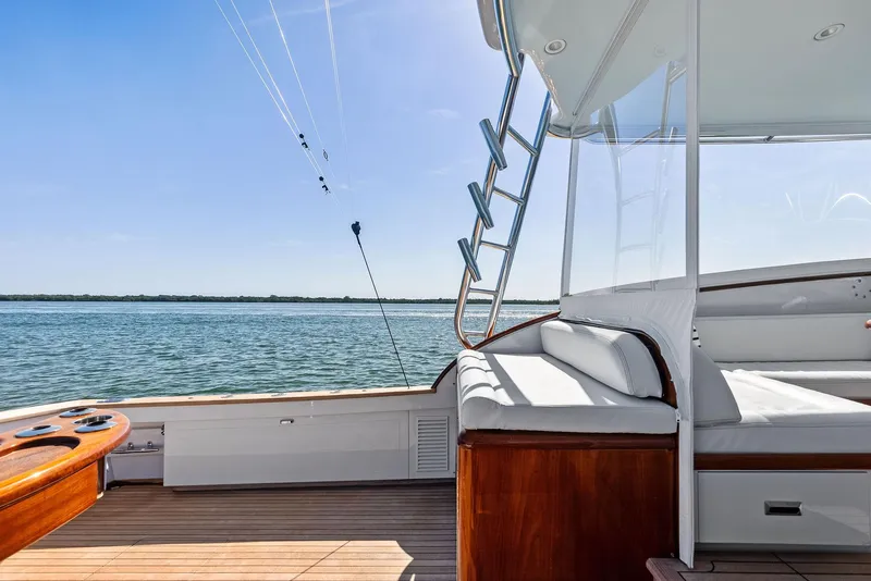 Slide: The Image of Rybovich Sportfish 2000 yacht deck with seating, overlooking calm ocean waters. - 21